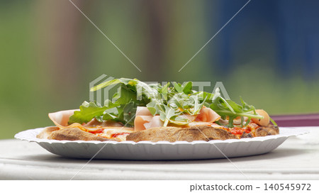 Fresh Prosciutto Pizza with Arugula at Outdoor Street Food Festival Fresh Prosciutto Pizza with Arugula at Outdoor Street Food Festival 140545972