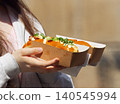 Woman holding loaded brioche buns at street food festival in karlin 140545994