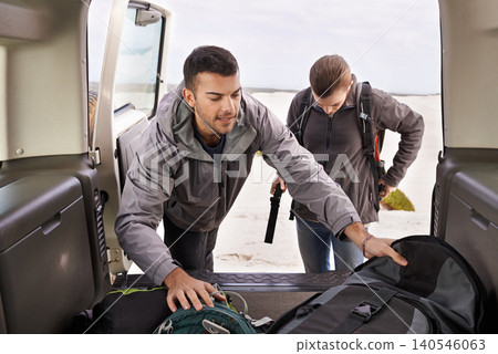 Car, man and woman outdoors for backpacking on vacation for adventure or travel, active and gear for road trip. Male, female explorers, tourists and jeep for camping and trekking, journey and nature. 140546063