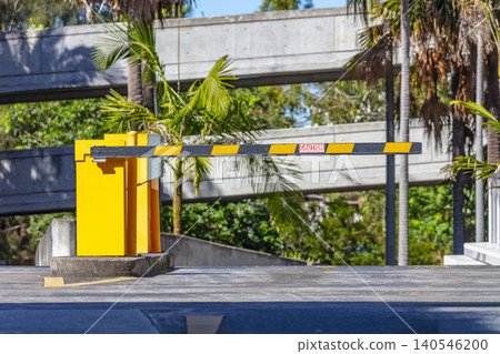 A boom gate at the entry and exit point to a public carpark A boom gate at the entry and exit point to a public carpark 140546200