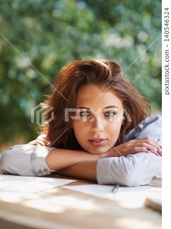 Tired, woman and portrait outdoor of studying on table with research, notes and paper in garden or backyard. Student, relax and rest with arms crossed or thinking of writing, project or learning 140546324