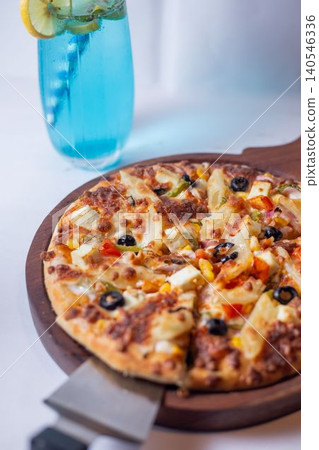 pizza with a glass of water, olives, ham and cheese 140546336
