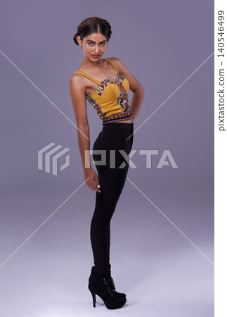 Portrait, fashion or woman in studio with heels, clothes or confidence for Spanish style or pride. Creative model, purple background or artist with trendy clothing, contemporary or modern aesthetics 140546499