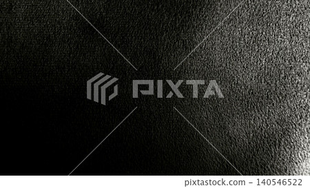 macro closeup of dramatic black rough textured surface with deep shadow and subtle highlight abstract minimalist mood 140546522