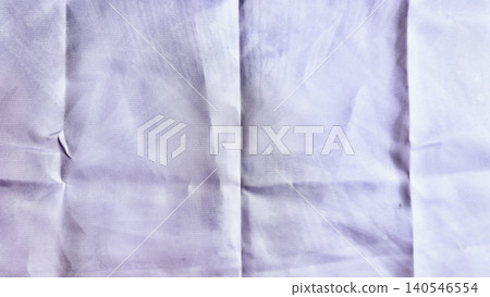crumpled white linen closeup with intricate wrinkles subtle tear and soft lavender glow evoking calm authenticity 140546554