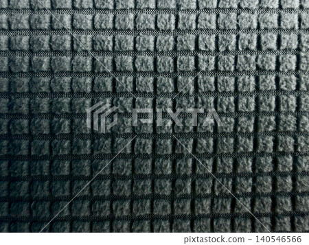 dark gray textured fabric closeup shows raised square grid pattern and horizontal weave lines in minimalist macro style dark gray textured fabric closeup shows raised square grid pattern and horizontal weave lines in minimalist macro style 140546566
