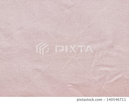 wrinkled pale pink organic cotton fabric texture background showing sustainable textile details in a minimalist flat lay wrinkled pale pink organic cotton fabric texture background showing sustainable textile details in a minimalist flat lay 140546711