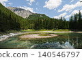 Crystal clear water of Gruner See with reflections in the Austrian Alps, capturing a pristine alpine lake landscape in spring 140546797
