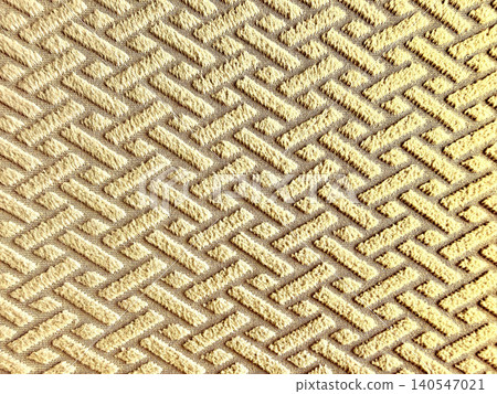 woven golden textile creates an intricate geometric pattern through soft plush ridges 140547021