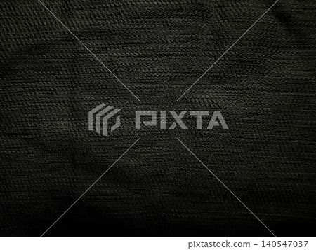 dark charcoal black woven fabric texture with detailed macro weave pattern showing subtle moody low key dramatic lighting 140547037