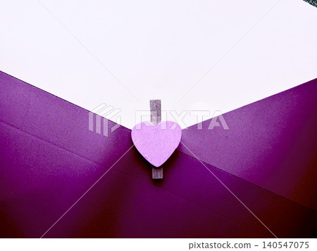 purple envelope with lavender heart clothespin creates minimalist romantic background purple envelope with lavender heart clothespin creates minimalist romantic background 140547075