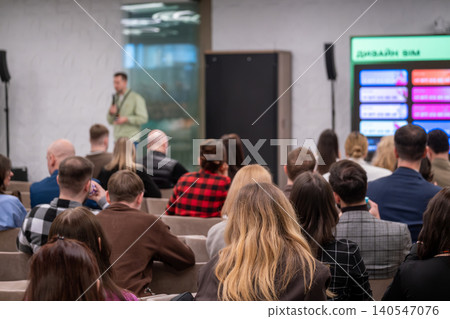Conference audience listening to speaker during business presentation in modern meeting room Conference audience listening to speaker during business presentation in modern meeting room 140547076