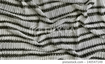 crumpled sustainable cotton knit blanket texture white and deep charcoal gray stripes close up background surface crumpled sustainable cotton knit blanket texture white and deep charcoal gray stripes close up background surface 140547149