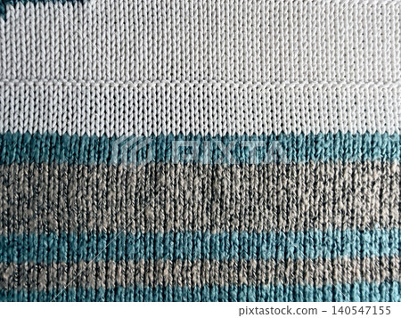closeup textured knitted wool stripe pattern blue cream beige textile detail 140547155