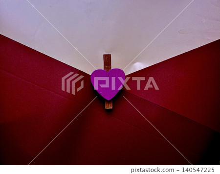 vibrant purple heart wooden clothespin secures romantic red envelope with tender intimacy 140547225