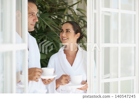 Spa, couple and happy with tea for wellness with bonding, relax and hospitality by door on vacation at hotel. Man, woman and smile with coffee for anniversary date, honeymoon and holiday retreat Spa, couple and happy with tea for wellness with bonding, relax and hospitality by door on vacation at hotel. Man, woman and smile with coffee for anniversary date, honeymoon and holiday retreat 140547245
