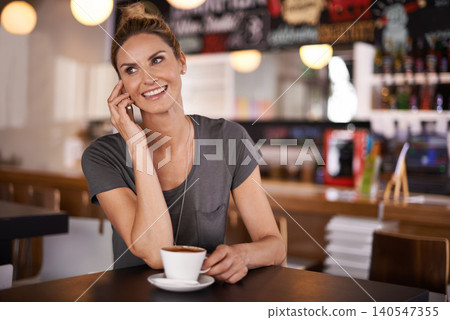 Happy, woman and phone call in coffee shop or relax in restaurant as customer in hospitality on holiday or vacation. Girl, smile and enjoy latte or espresso with virtual chat on smartphone in morning 140547355