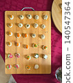 Canapes are arranged on wooden board with sauces, herbs, cheese, and garnish for catering service. Top view. Concept of canapes menu, reception snacks, tasting buffet, party food display 140547364