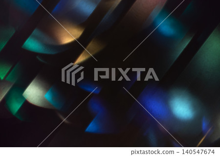 Abstract colorful light reflections and shadows creating a dynamic pattern on a dark background, showcasing vibrant hues and shapes in a visually striking composition Abstract colorful light reflections and shadows creating a dynamic pattern on a dark background, showcasing vibrant hues and shapes in a visually striking composition 140547674
