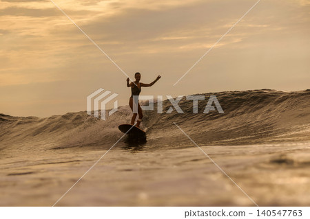 Woman Enjoying Sunset With Joyful Expression And Peaceful Coastal Surroundings 140547763