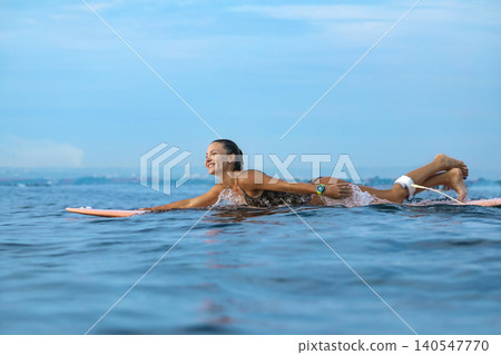 Lively Young Lady Happily Paddles Through Serene Turquoise Waters On Sunny Coast Lively Young Lady Happily Paddles Through Serene Turquoise Waters On Sunny Coast 140547770