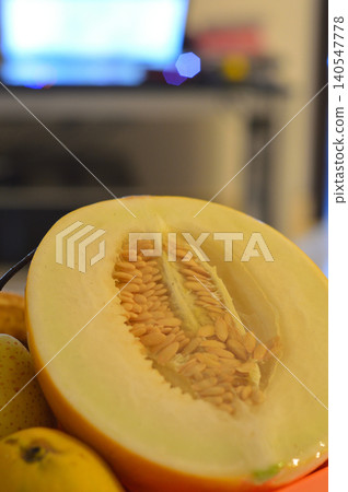 Sliced melon close-up with seeds and pears Sliced melon close-up with seeds and pears 140547778