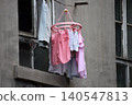 Clothes drying outside an old apartment window 140547813