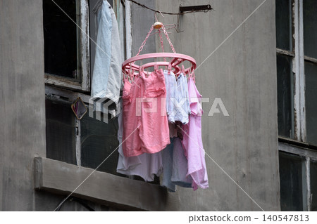 Clothes drying outside an old apartment window Clothes drying outside an old apartment window 140547813