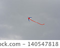 Colorful kite flying in a cloudy sky 140547818