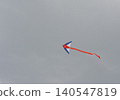 Colorful kite flying in a cloudy sky 140547819