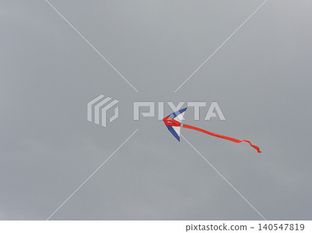 Colorful kite flying in a cloudy sky Colorful kite flying in a cloudy sky 140547819