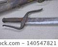 Old sword with worn handle on fabric 140547821