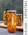 Pickled mushrooms in glass jars for food preservation 140547841