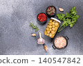 Pickled mushrooms jar with spices and herbs on dark surface 140547842