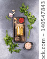 Pickled mushrooms in oil with spices and fresh herbs 140547843