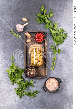 Pickled mushrooms in oil with spices and fresh herbs Pickled mushrooms in oil with spices and fresh herbs 140547843