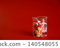 Colorful heart-shaped chocolates in a beaker 140548055
