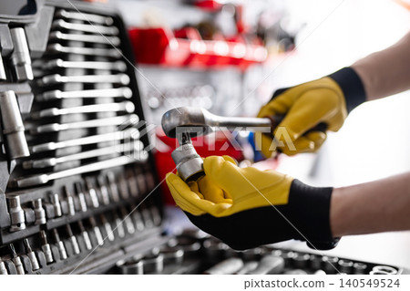 Auto Mechanic With Ratchet Wrench With Socket Tool Auto Mechanic With Ratchet Wrench With Socket Tool 140549524
