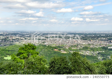 A spectacular view from the hiking trail of Mt. Hiwada, showing the winding Kinchakuda area below and the distant, hazy mountain range (Hidaka City, Saitama Prefecture). A spectacular view from the hiking trail of Mt. Hiwada, showing the winding Kinchakuda area below and the distant, hazy mountain range (Hidaka City, Saitama Prefecture). 140550773