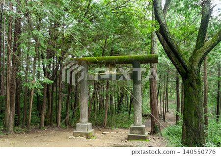 The first torii gate of Kotohira Shrine stands majestically on the hiking trail of Mt. Hiwada, offering a magnificent view of the townscape spread out below (Hidaka City, Saitama Prefecture). 140550776