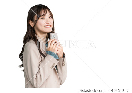 Young Asian businesswoman in urban office district holding smartphone Young Asian businesswoman in urban office district holding smartphone 140551232