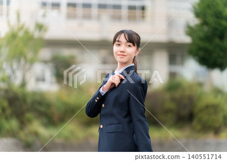 Junior high school, high school, and elementary school students in uniform standing in front of the school building Junior high school, high school, and elementary school students in uniform standing in front of the school building 140551714