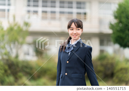 Middle school, high school, and elementary school girls in school uniforms standing in front of the school building. Middle school, high school, and elementary school girls in school uniforms standing in front of the school building. 140551715