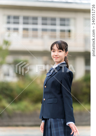 Middle school, high school, and elementary school girls in school uniforms standing in front of the school building. Middle school, high school, and elementary school girls in school uniforms standing in front of the school building. 140551716