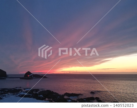A stunning aerial view of a vibrant sunset from the coastline of Utoro, Hokkaido. A stunning aerial view of a vibrant sunset from the coastline of Utoro, Hokkaido. 140552023