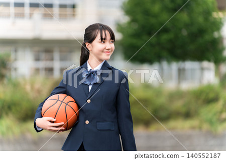 穿著校服的高中、國中和小學女生站在校園裡,手裡拿著籃球 穿著校服的高中、國中和小學女生站在校園裡,手裡拿著籃球 140552187