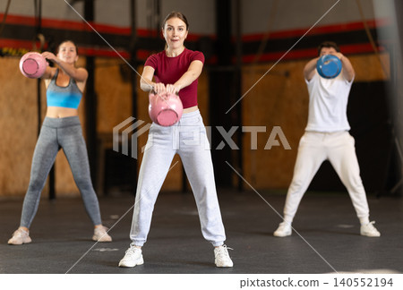Woman exercising with a kettlebell Woman exercising with a kettlebell 140552194
