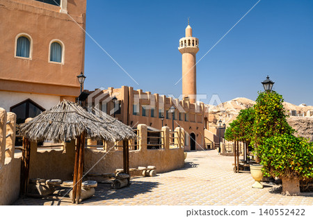 Traditional architecture and minaret at the Land of Civilizations tourist attraction by Al Qarah Mountain in Al Ahsa, Saudi Arabia. 140552422