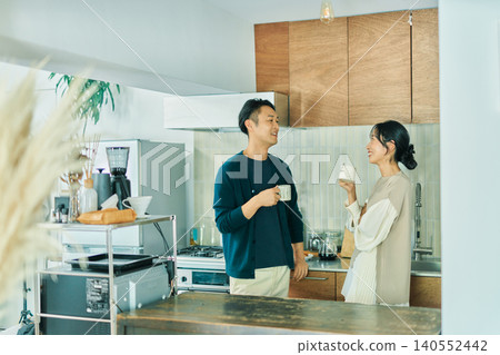 A couple who talks in the kitchen A couple who talks in the kitchen 140552442