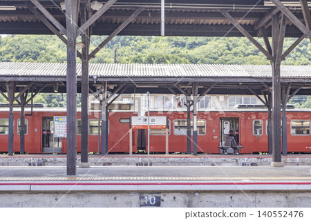 A KiHa 40 train on the Tsuyama Line stopped at Tsuyama Station. A KiHa 40 train on the Tsuyama Line stopped at Tsuyama Station. 140552476
